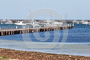 The Port MacDonnell jetty with commercial fishing boats in the background taken in South Australia on November 10th 2020