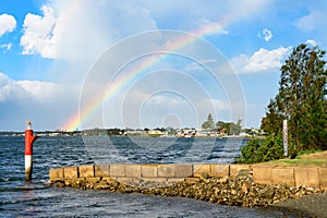 Port Macquarie, a colorful rainbow in the cloudy sky over the Hastings River, view from the kayak pier after heavy rain photo