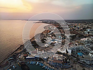 port near the shore on the background of a beautiful sunset. Mediterranean coast of Cyprus, Ayia NAPA