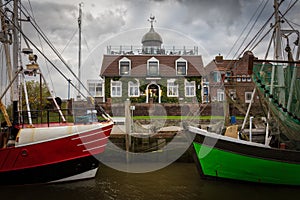 The port of Neuharlingersiel with two old fish trawlers.