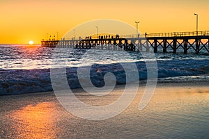 Port Noarlunga beach with pier and people at sunset