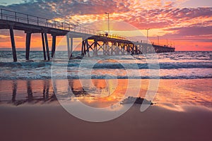 Port Noarlunga jetty with people during pink sunset