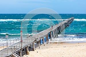 The Port Noarlunga Jetty with rough seas in Adelaide South Australia on 6th November 2019