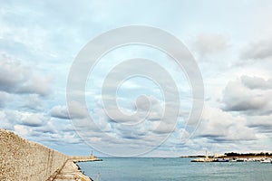 Port of Ostuni, blue sea, sky and white clouds, Apulia, Italy