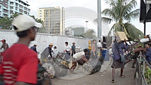 PORT, QUAY & JETTY: ASIA - Porters carry goods on gangway with ship visible