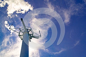 Port radar installation for navigation in the harbor against blue cloudy sky