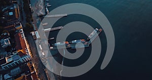 Port for ships in the city by the sea. Aerial establisher. 4k drone flight. Film vintage colors. top view.