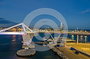 Port Vell with its cruise terminal, bridge Porta d`Europa and W Barcelona at night