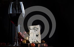 Port wine and blue cheese, still life in rustic style, vintage wooden table background, selective focus