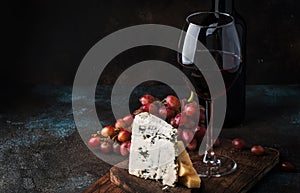 Port wine and blue cheese, still life in rustic style, vintage wooden table background, selective focus