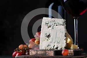 Port wine and blue cheese, still life in rustic style, vintage wooden table background, selective focus