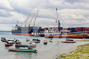 Port of Zanzibar with big ships, cranes and cargos near the quay in Stone Town, Zanzibar, Tanzania photo