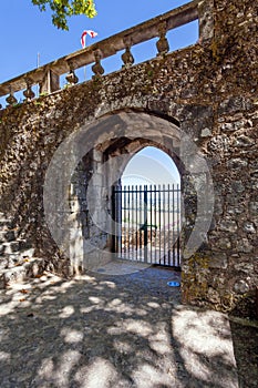 Porta do Sol Gate built into the medieval castle wall in Portas do Sol Garden.