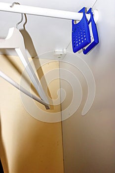Portable air freshener hanging on a clothes rack inside a Wardrobe