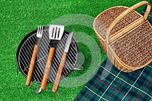 Portable Barbecue Grill On Lawn, Tools, Picnic Basket And Blanket