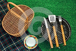 Portable Barbecue Grill On Lawn, Tools, Picnic Basket And Blanket