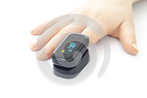 Portable black pulse oximeter on a white background. Monitoring the oxygen level at home. Covid-19, a heart rate health tester is