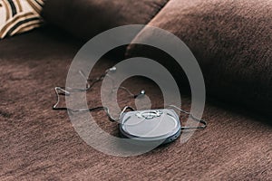 Portable cd player known as discman leaning on sofa at home photo