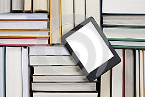 Portable e-book reader on different hardcover books, top view