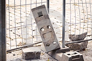 Portable fence concrete parts weight racks that hold the stability of the metal fencing on construction site
