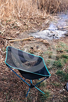 Portable, folding camping chair for hiking trips. Aluminum frame and durable fabric. Light weight and compact