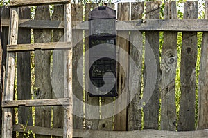 Portable folding solar panel battery hanging on a wooden fence n