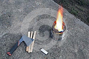 Portable folding wood stove. Fire burns brightly