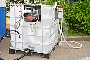 Portable fuel tank with pipes, pump and measuring meter. Mini portable diesel storage tank station