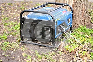 Portable Generator - Outdoor Power Equipment. Mobile backup power generator in the garden