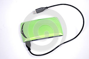 The portable hard drive for the computer with the connected wire on a white background.