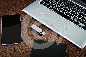 A portable hdd connected to a laptop with usb flash drive and smartphone