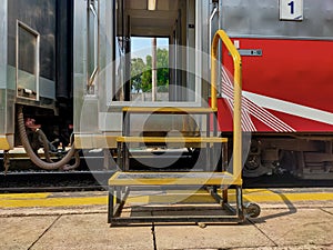 A portable ladder that passengers use to board and disembark train cars at a train station