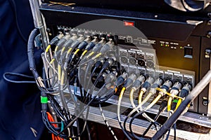Portable PA Systems. Cables plugged in the inputs of mixing console of a sound engineer. Closeup.