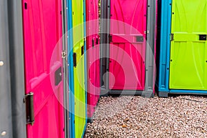 Portable plastic toilets in bright colors, placed on the street during an event