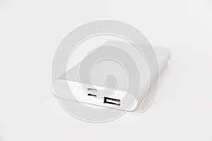 Portable power bank for charging mobile devices, on white background