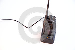 Portable radio Walkie-talkie on charging station, isolated on white background