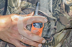 Portable radios in human hands and on clothing items