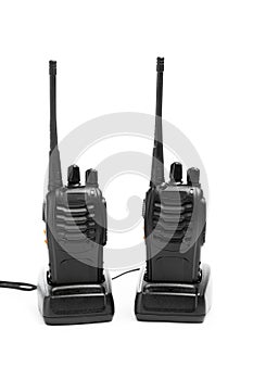 Portable radios Walkie-talkie on charging stations, isolated on white