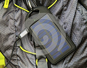 Portable solar cell hanging on tourist backpack