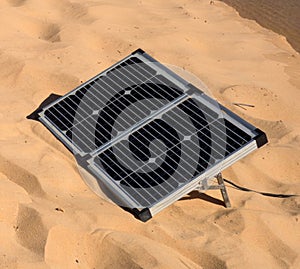 Portable solar panels providing power at a beach in the desert