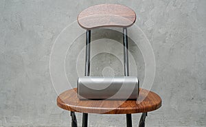 Portable speaker on wooden chair for music connection with loft wall background