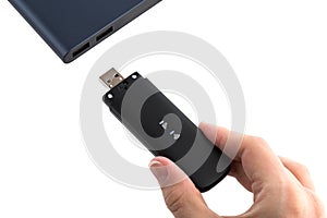 Portable usb modem and hand on a white background.