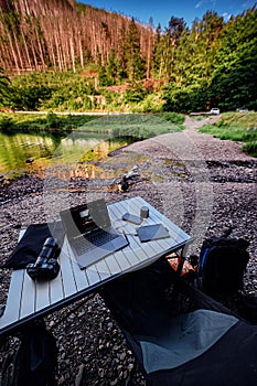 Remote Workstation by a Scenic Forest Riverbank