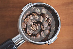 Portafilter with coffee beans close-up