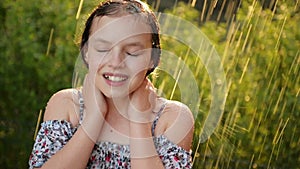 Portait of Adorable Little Girl. She Is Playing Happily In the Rain On Warm Summer Day.