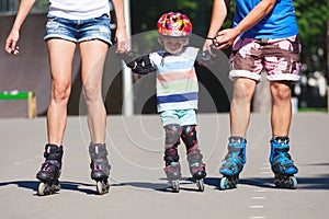 Portait of baby boy learning inline skating.