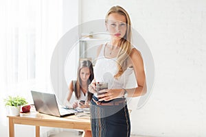 Portait of beautiful successful business woman holding cup coffee looking confident and serious