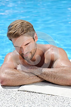 Portait of a handsome man by the pool