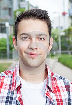 Portait of a smiling student with checked shirt photo