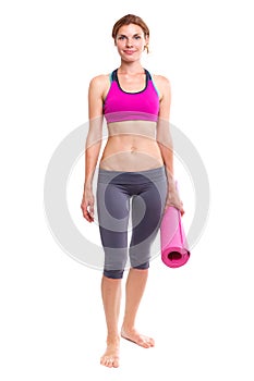 Portait of young woman with yoga mat.